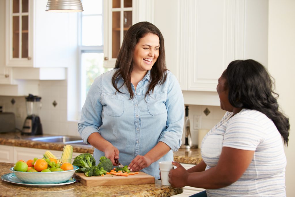 two women in the kitchen cooking