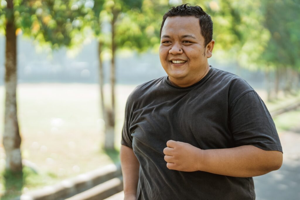 man with toothy smile jogging in the morning